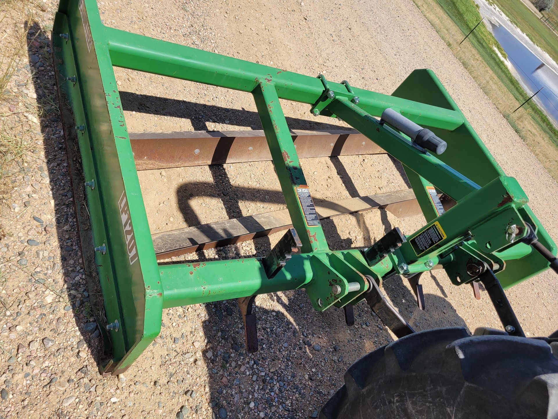 An aerial view of a tractor plowing a field.