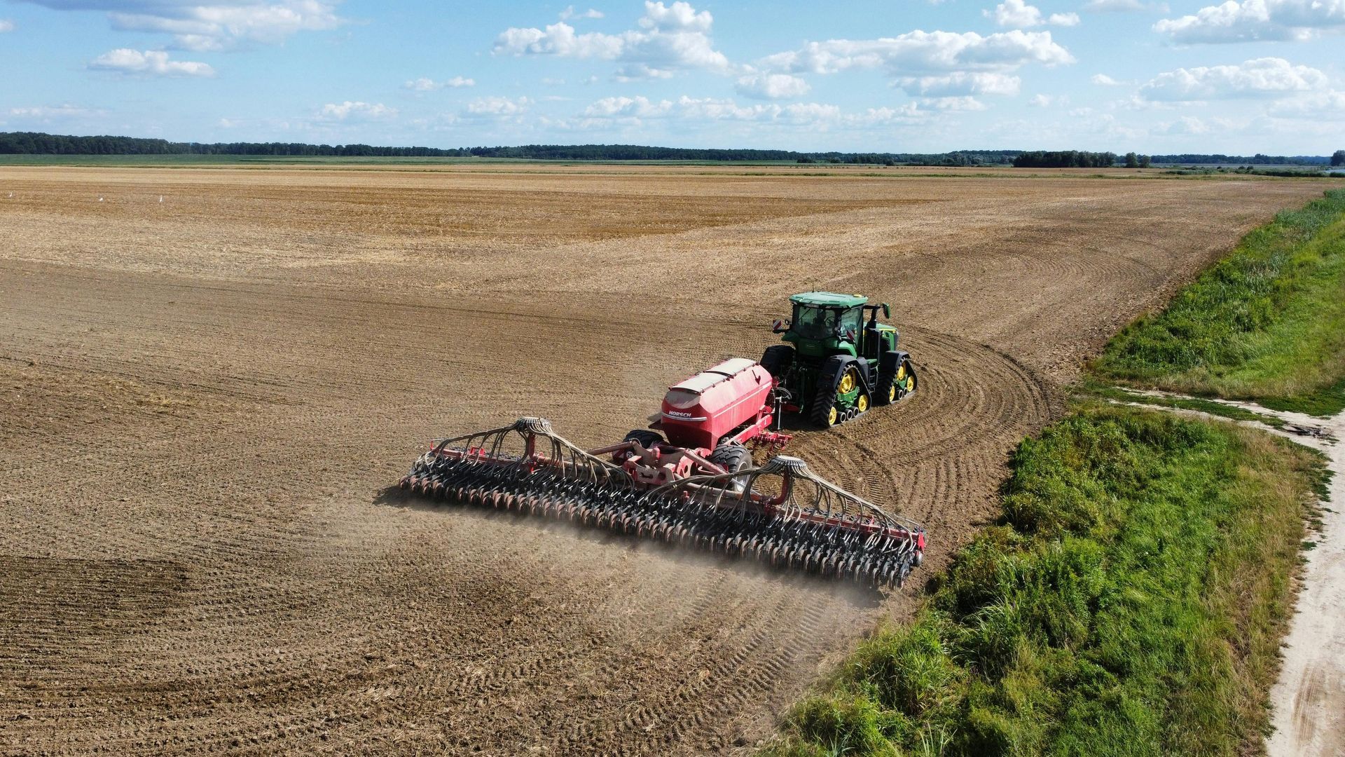 An aerial view of a tractor plowing a field.