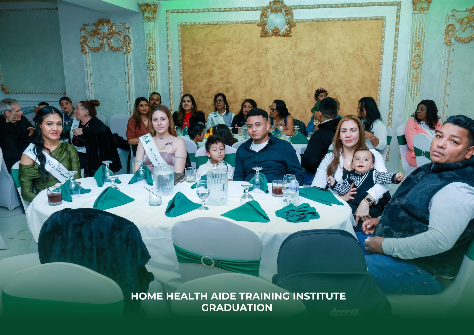 A group of people are sitting around a table at a graduation party.