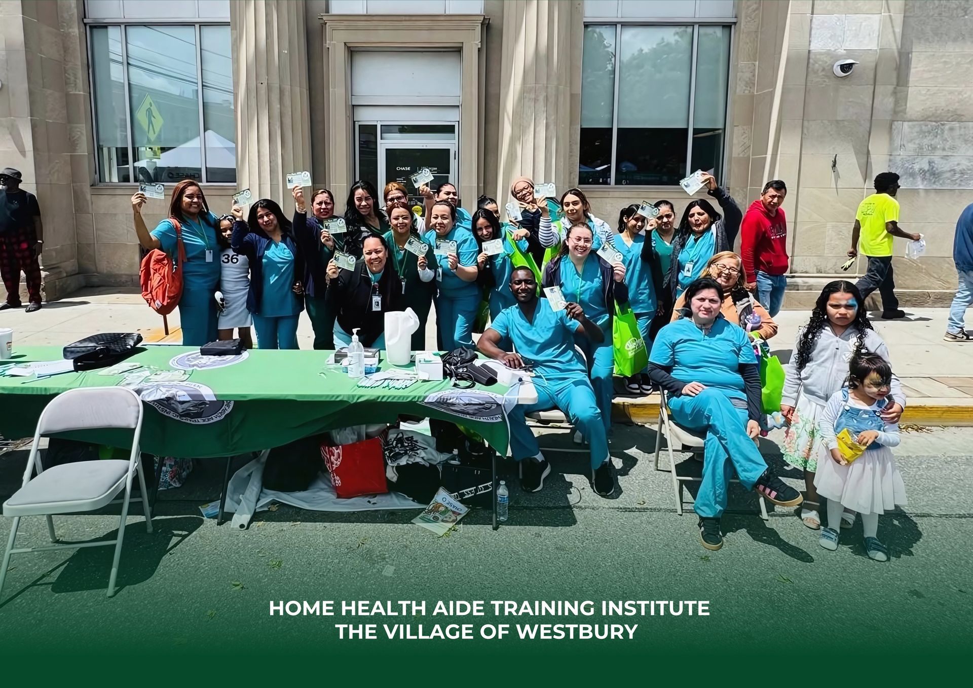 A group of people posing for a picture in front of a building that says home health aide training institute