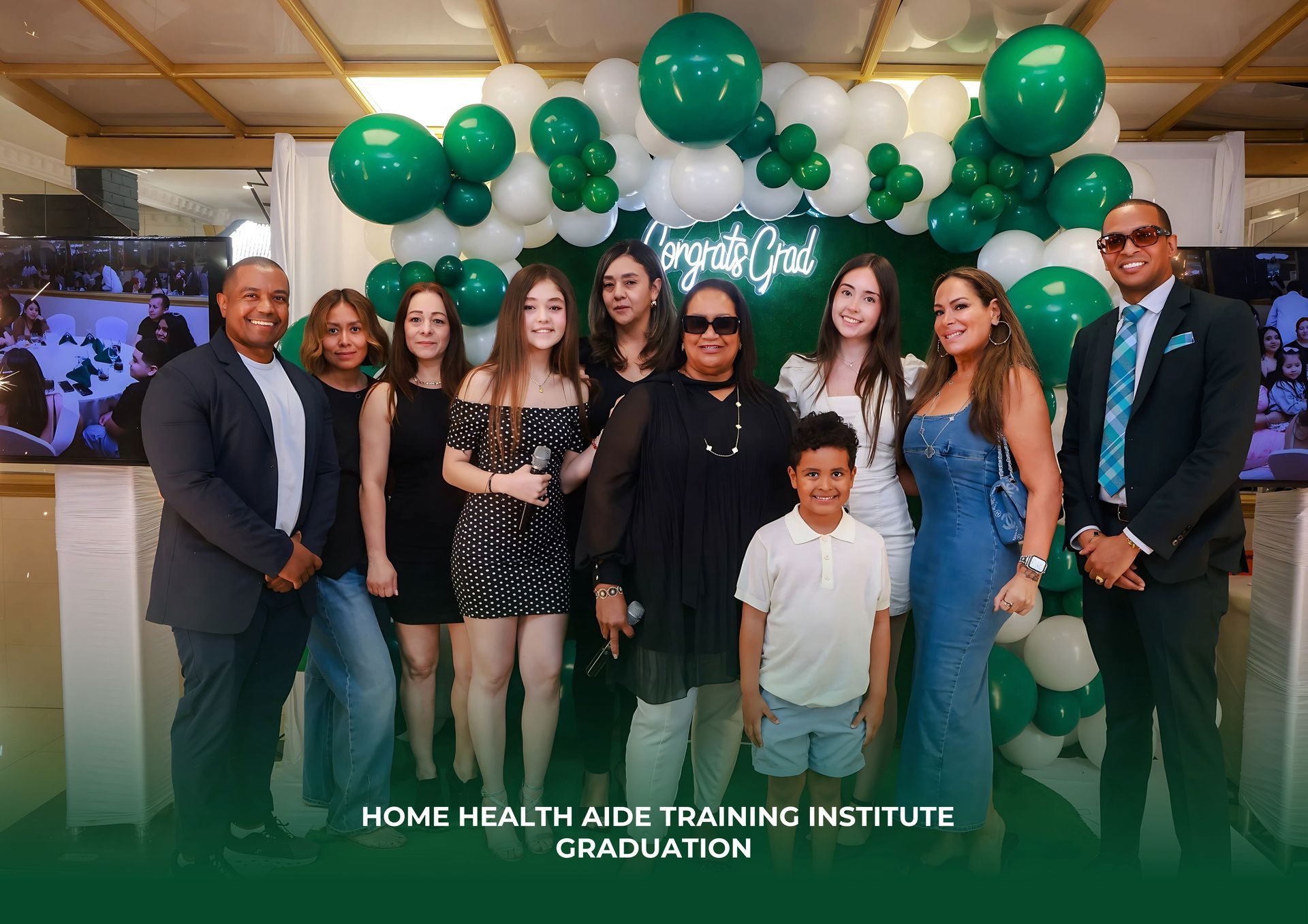 A group of people are posing for a picture in front of balloons.