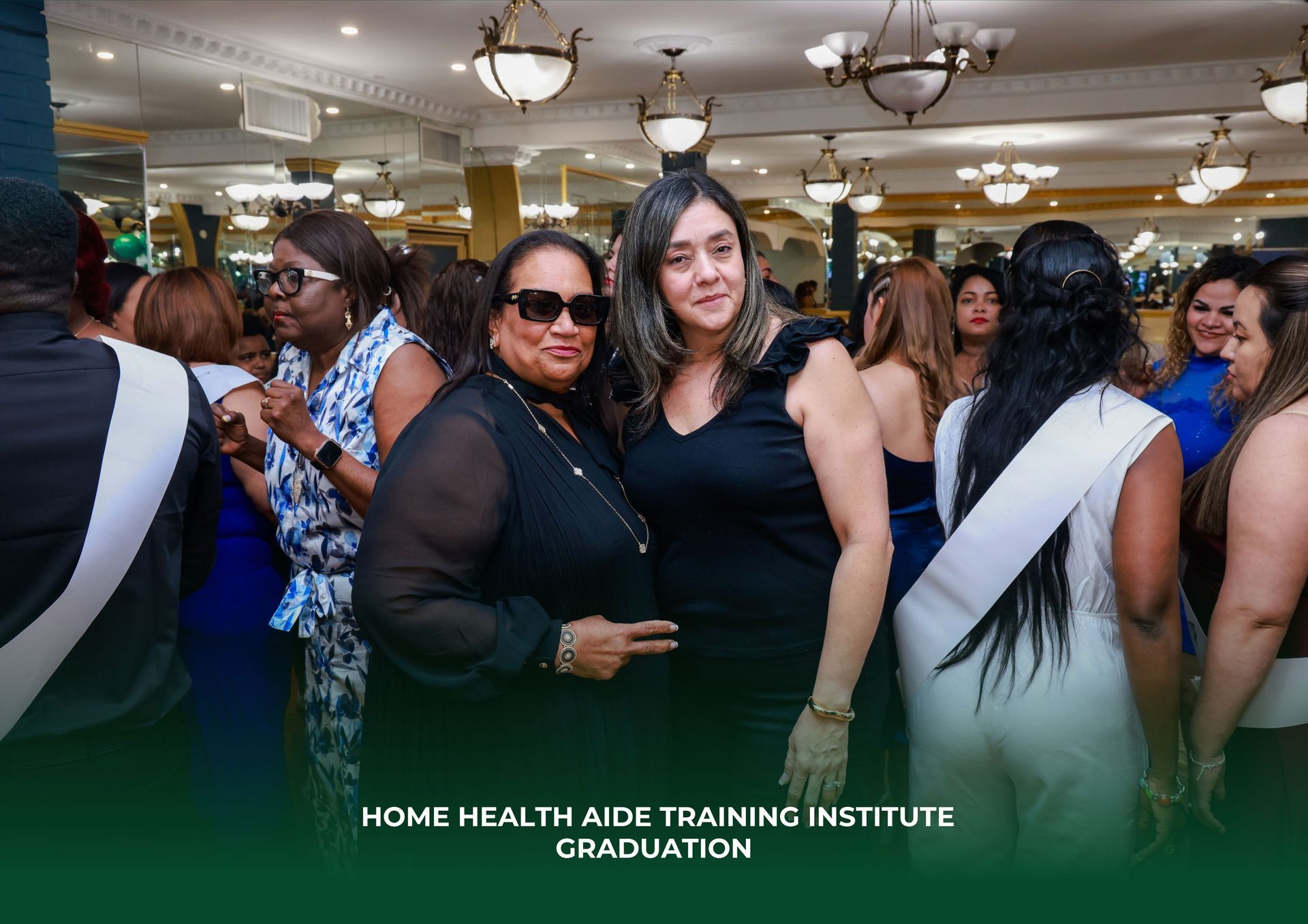 Two women are posing for a picture at a graduation ceremony.
