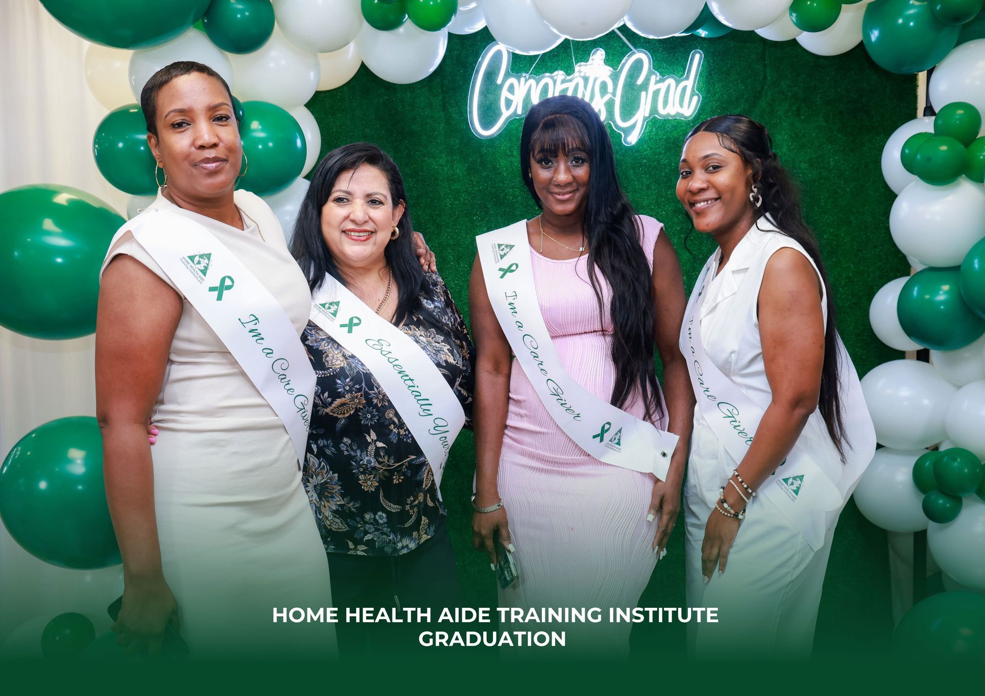 A group of women are posing for a picture in front of balloons.