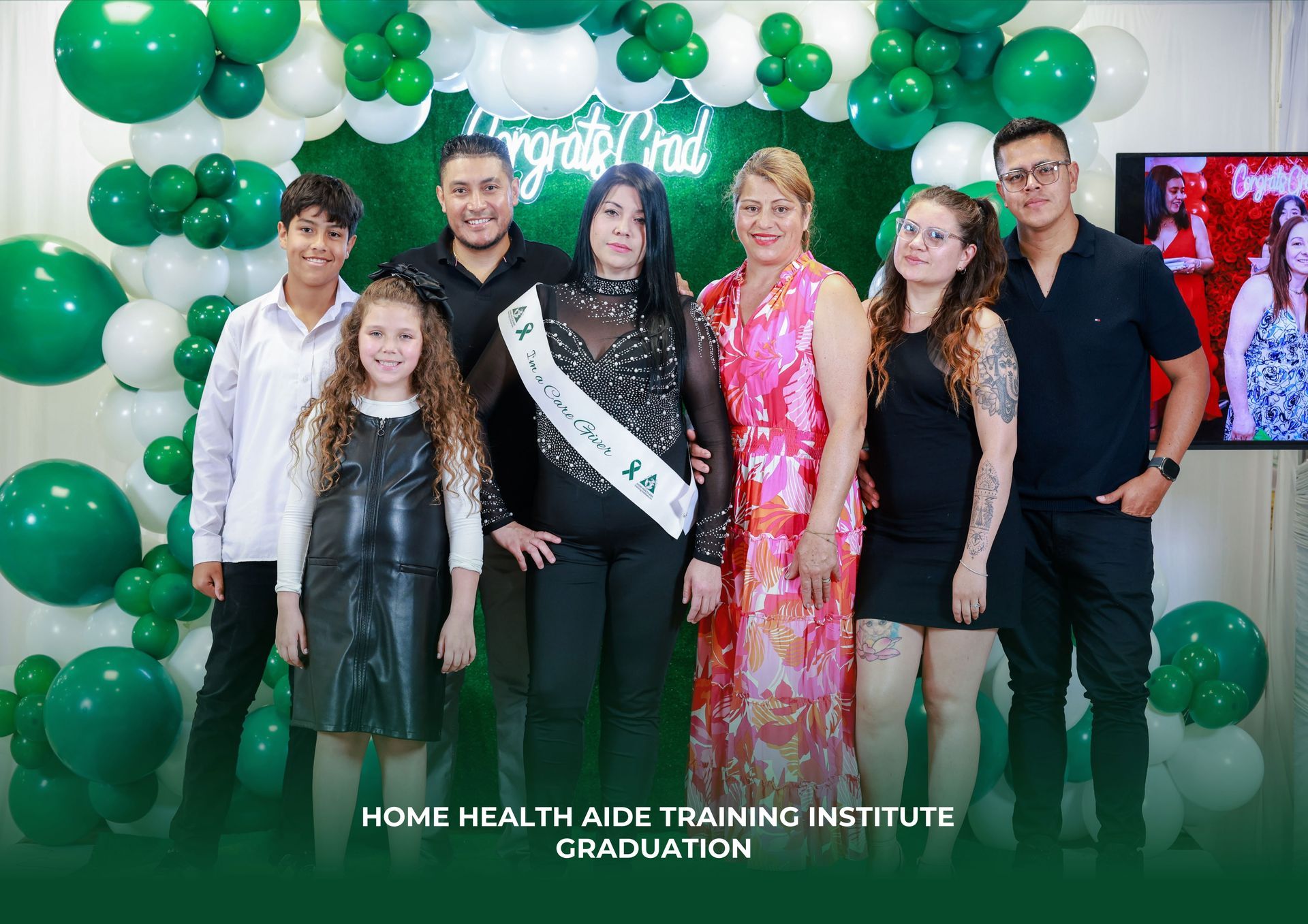 People are posing for a picture in front of balloons.