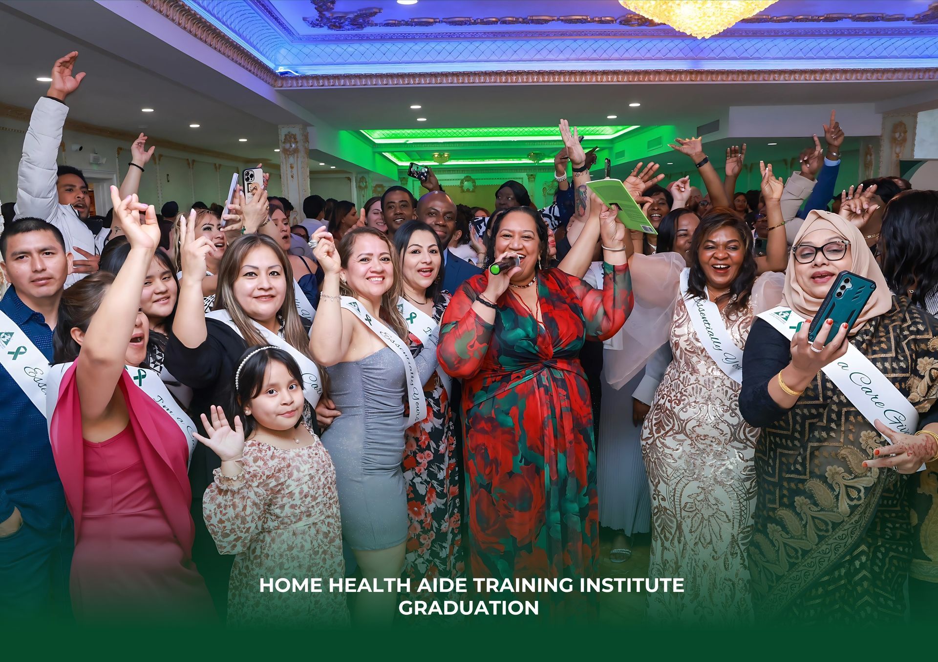 A group of people are standing in a room with their hands in the air.