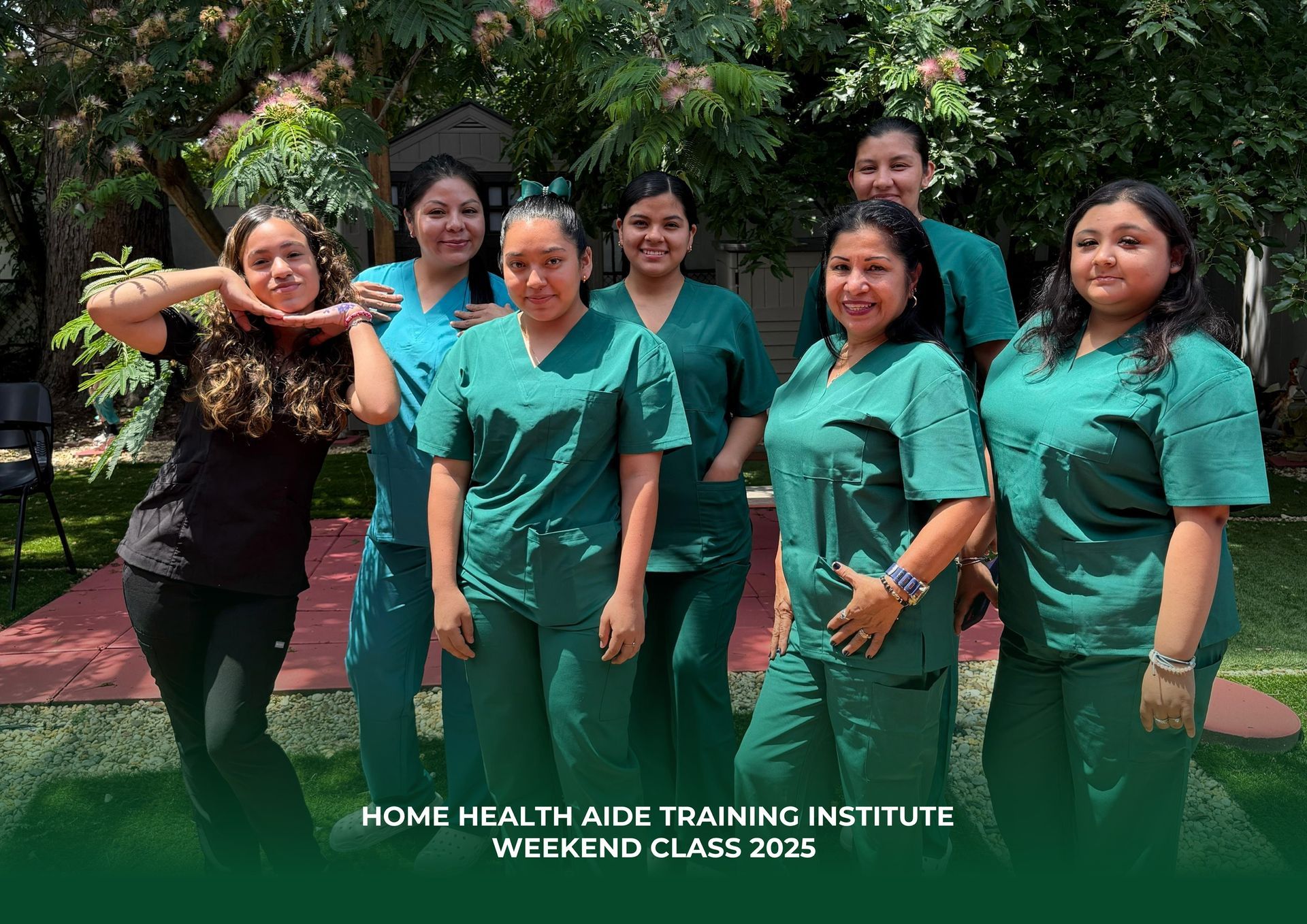 A group of women in green scrubs are posing for a picture.