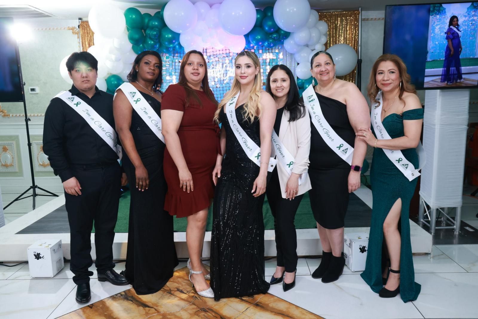 A group of people standing next to each other in a room.