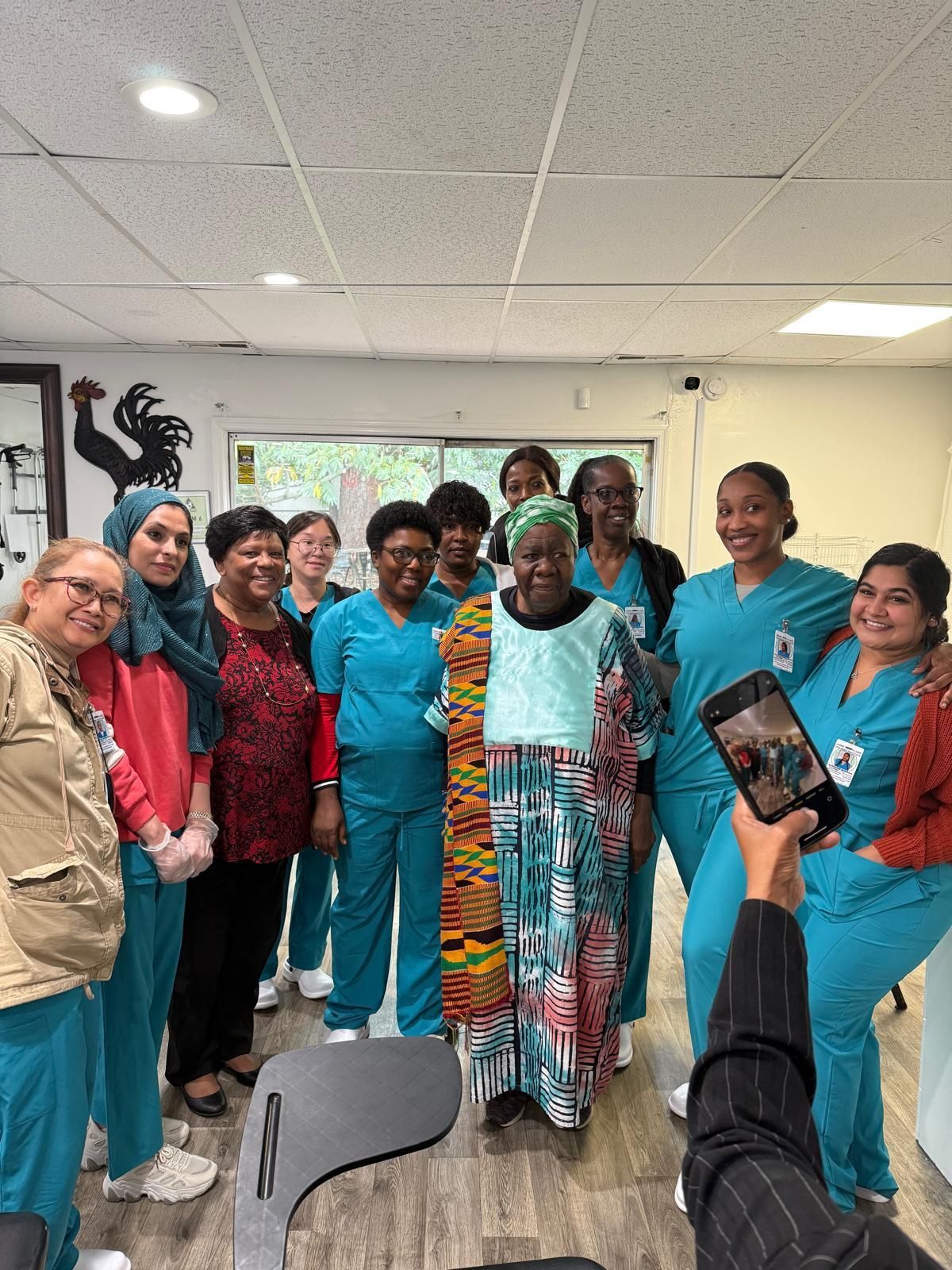 A group of nurses are posing for a picture in a room.