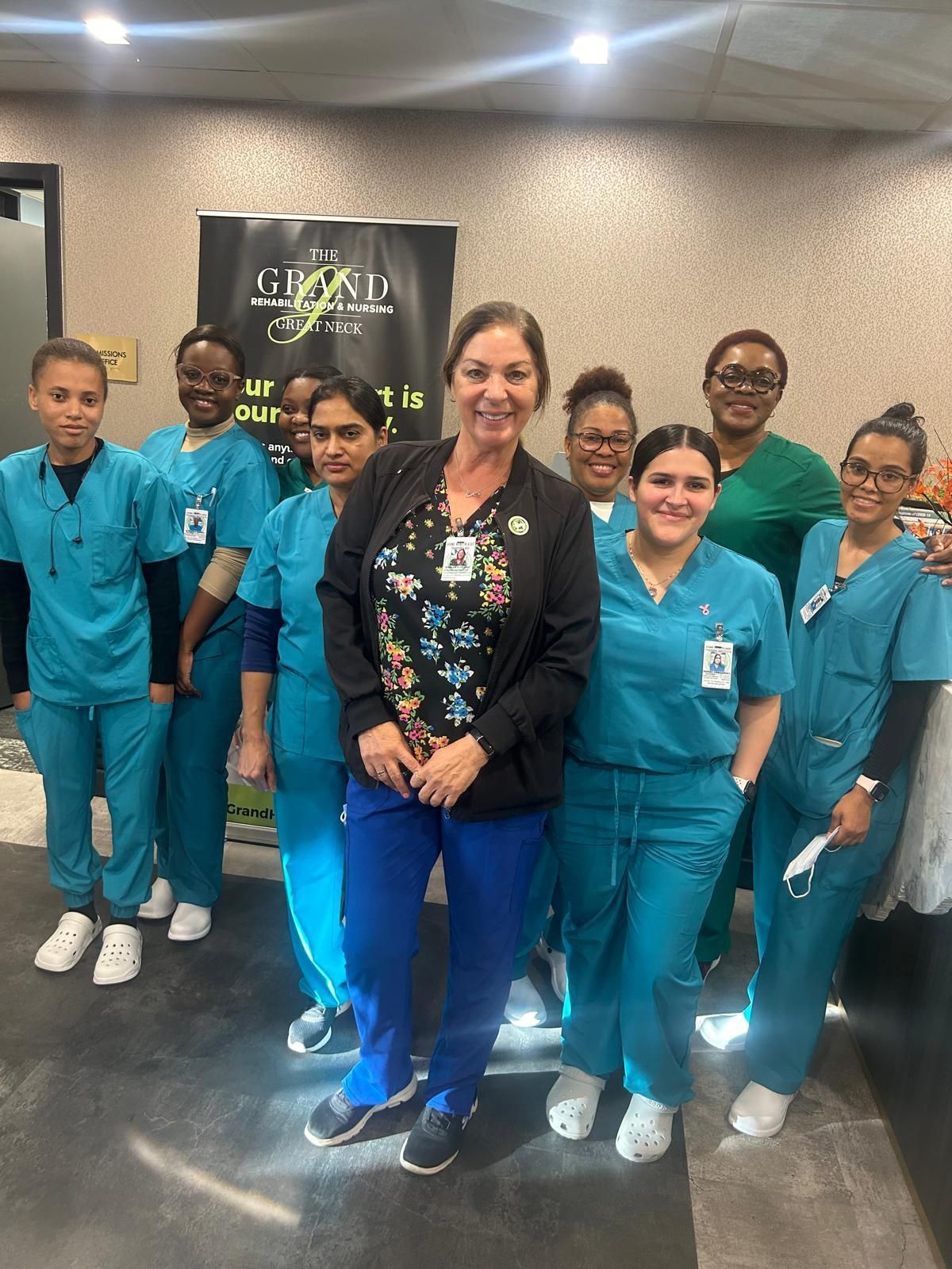 A group of nurses is posing for a picture.