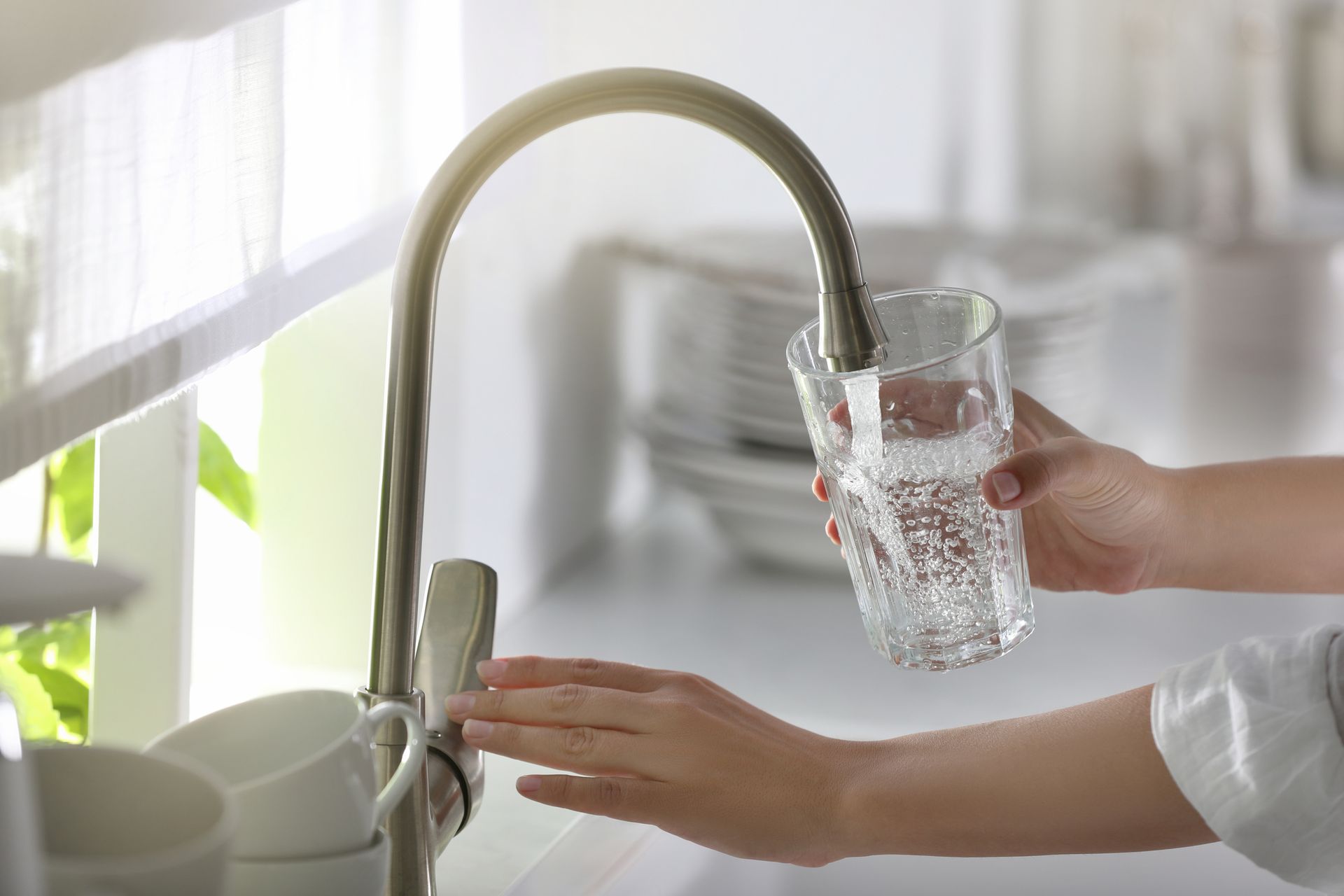 A water filter is sitting on a counter next to a tank.