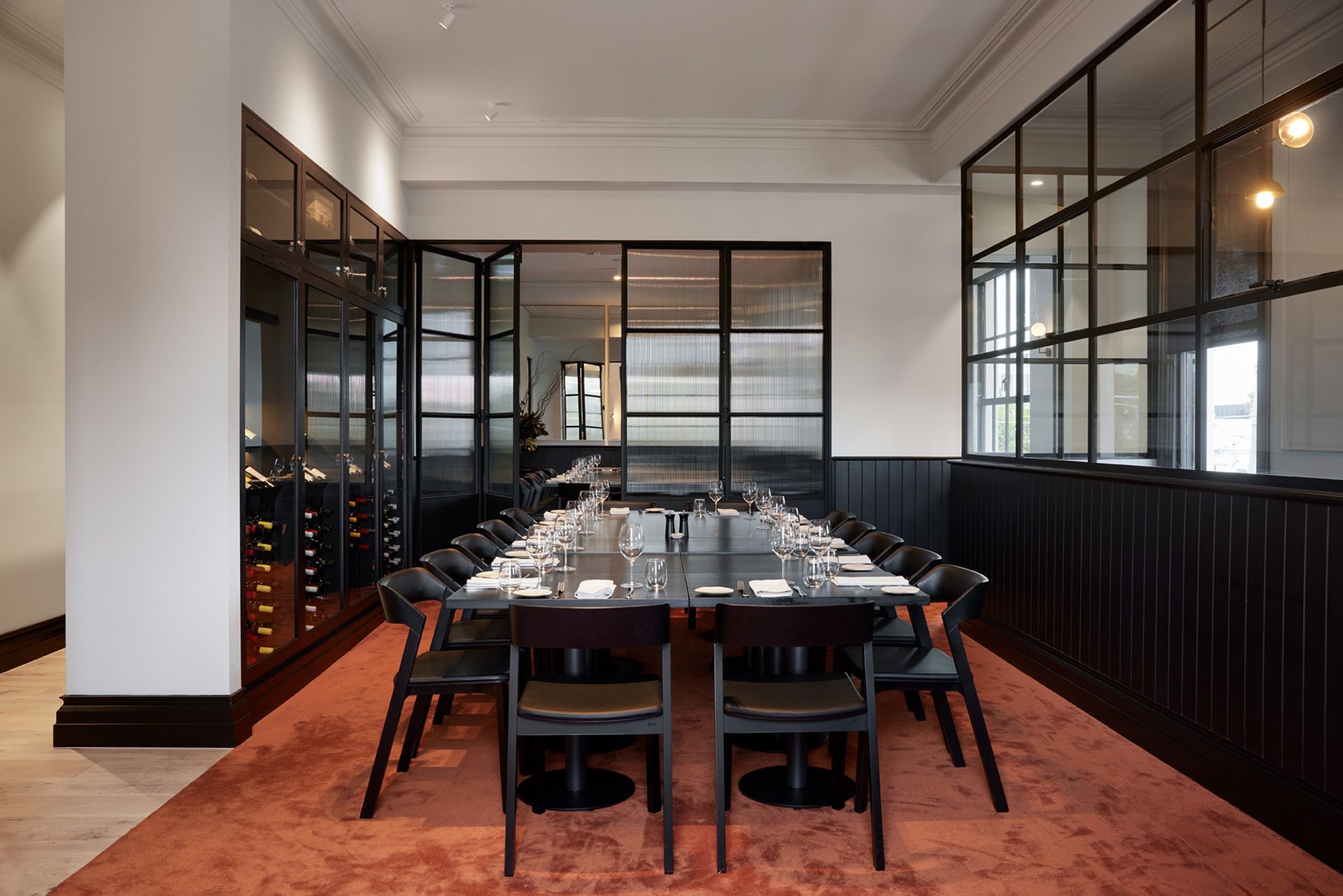 There is a long table and chairs in the room.