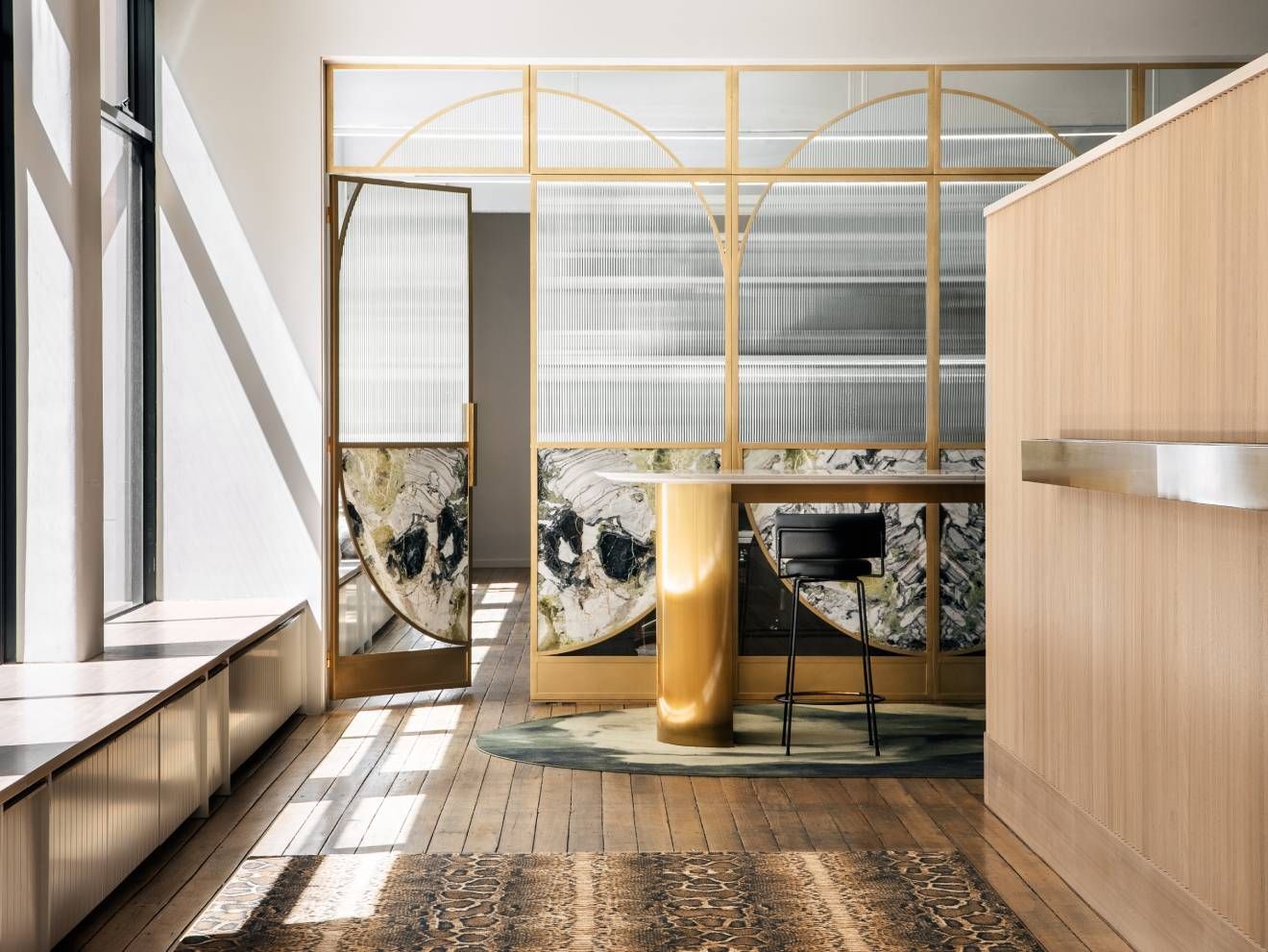 A room with a wooden floor and a glass wall.