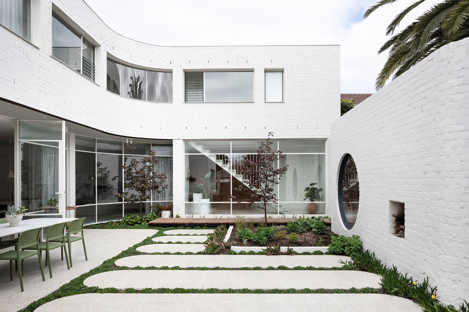 A large white building with a circular window in the middle of it
