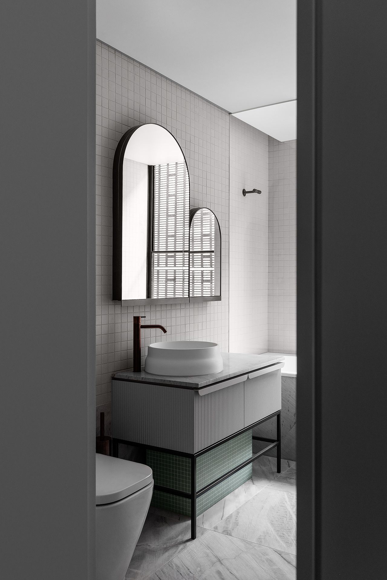 A bathroom with a sink , toilet and mirror.