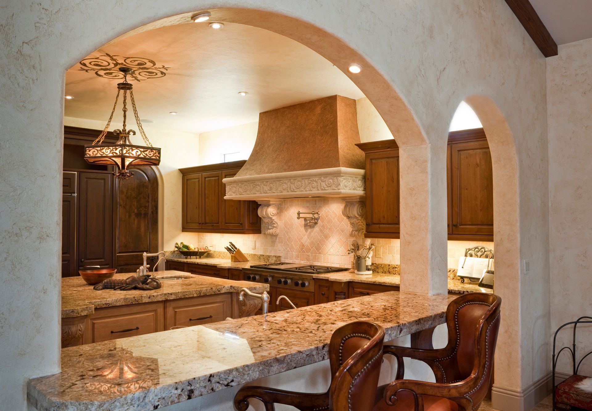 A kitchen with wooden cabinets and granite counter tops.