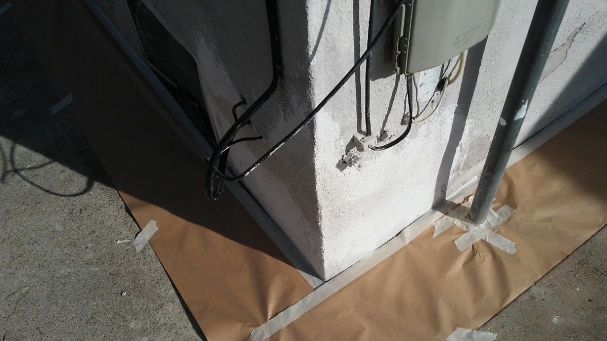 A corner of a building with tape on it.