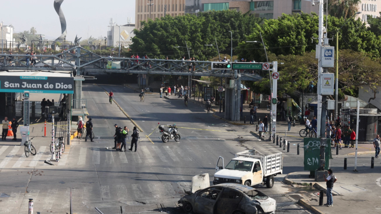 Large barge in the water docking at a large port.