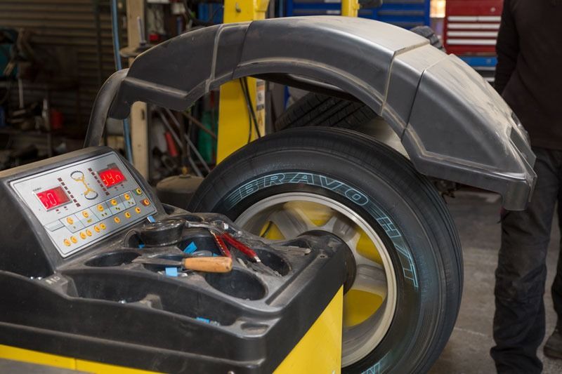 A Tyre Is Being Balanced On A Machine In A Garage — CS Mechanical Repairs & Services In Wauchope, NSW