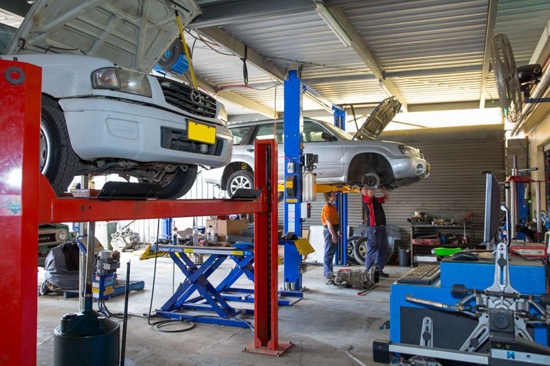 A Car Is On A Lift In A Garage — CS Mechanical Repairs & Services In Wauchope, NSW