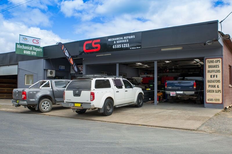 Three Trucks Are Parked In Front Of A Garage — CS Mechanical Repairs & Services In Wauchope, NSW