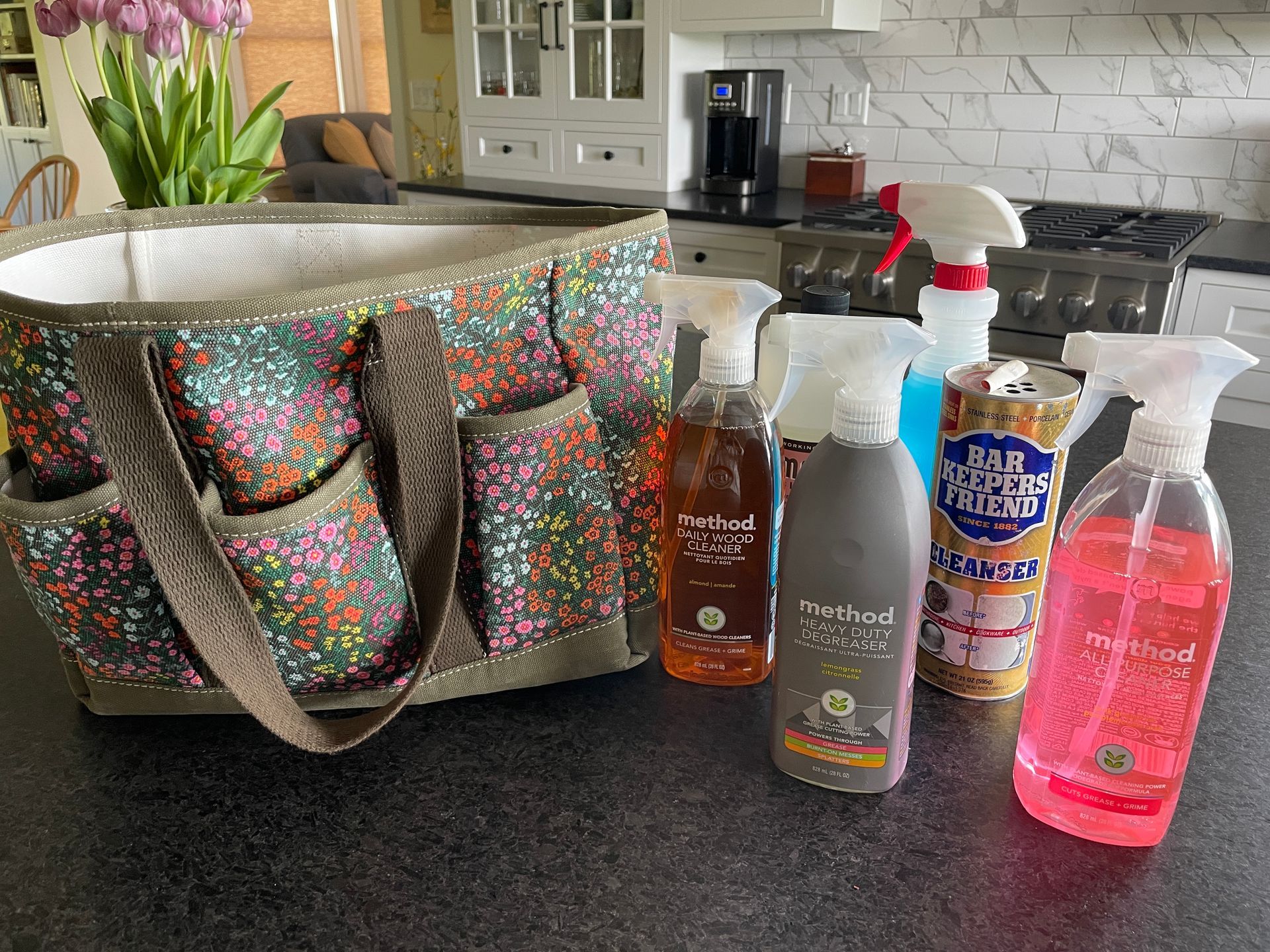 A tote bag is sitting on a counter next to bottles of cleaning supplies.