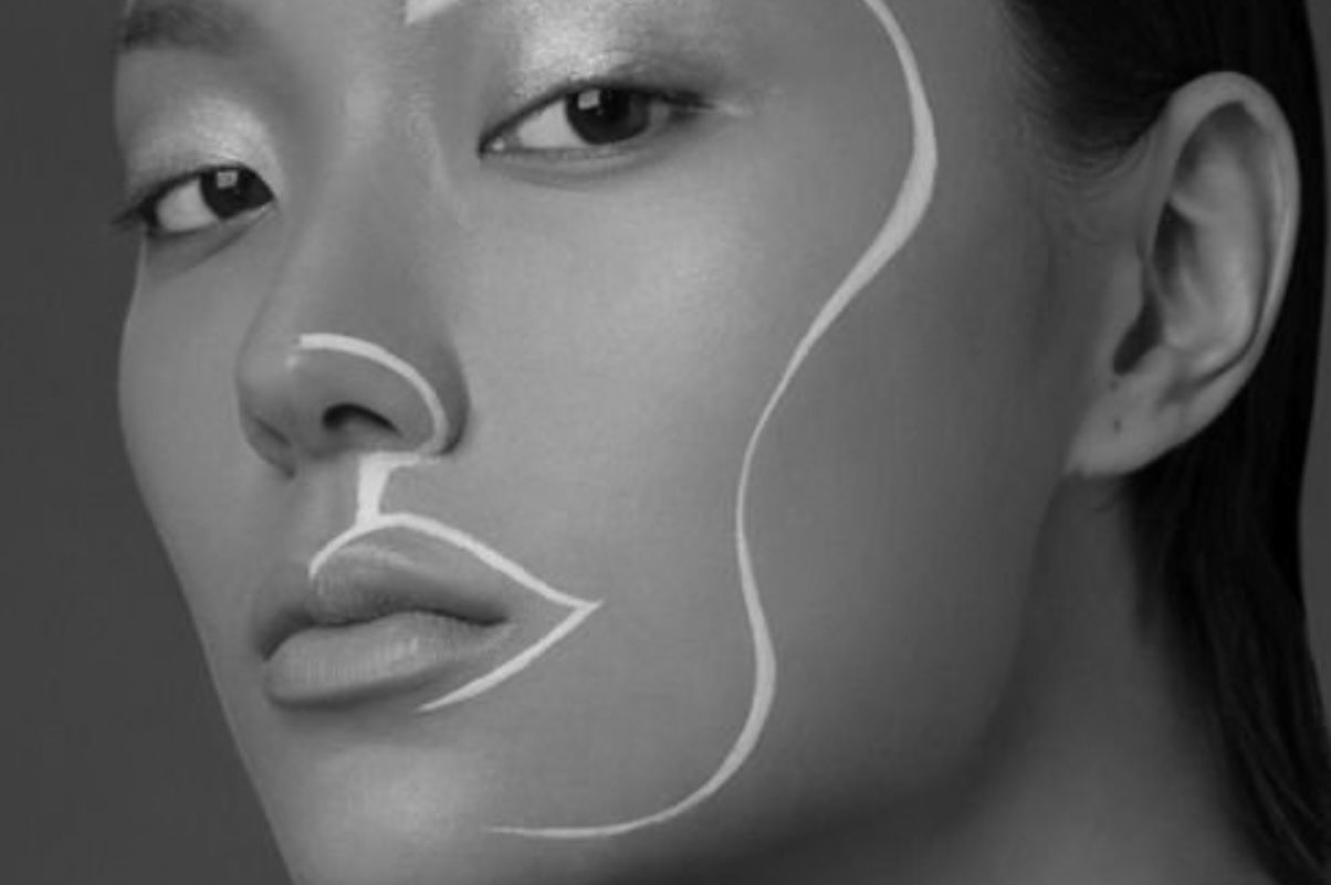 A black and white photo of a woman 's face with a line drawn on it.
