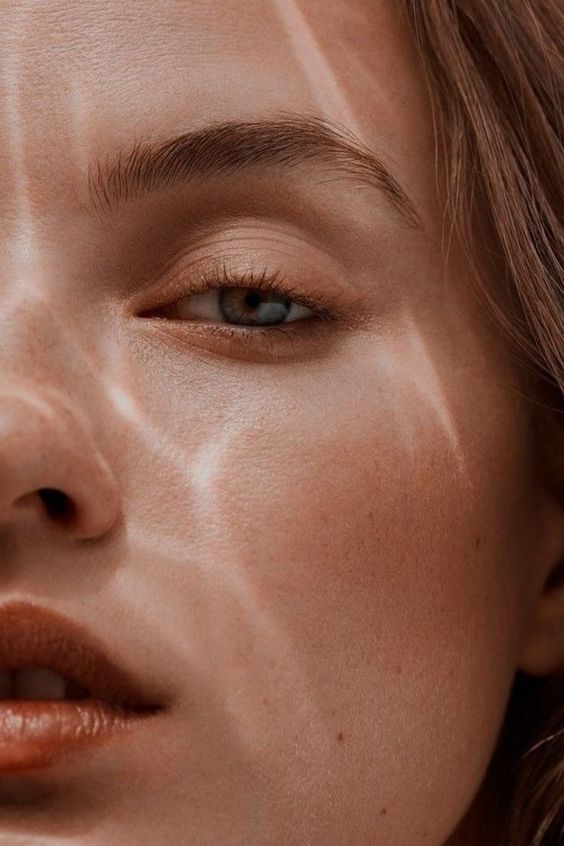 A close up of a woman 's face with her eyes closed.