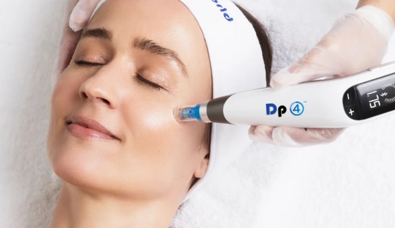 A woman is getting a treatment on her face with a machine.