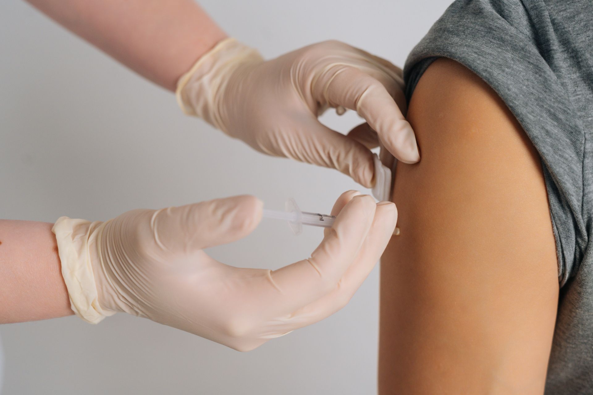 A person is getting an injection in their arm.