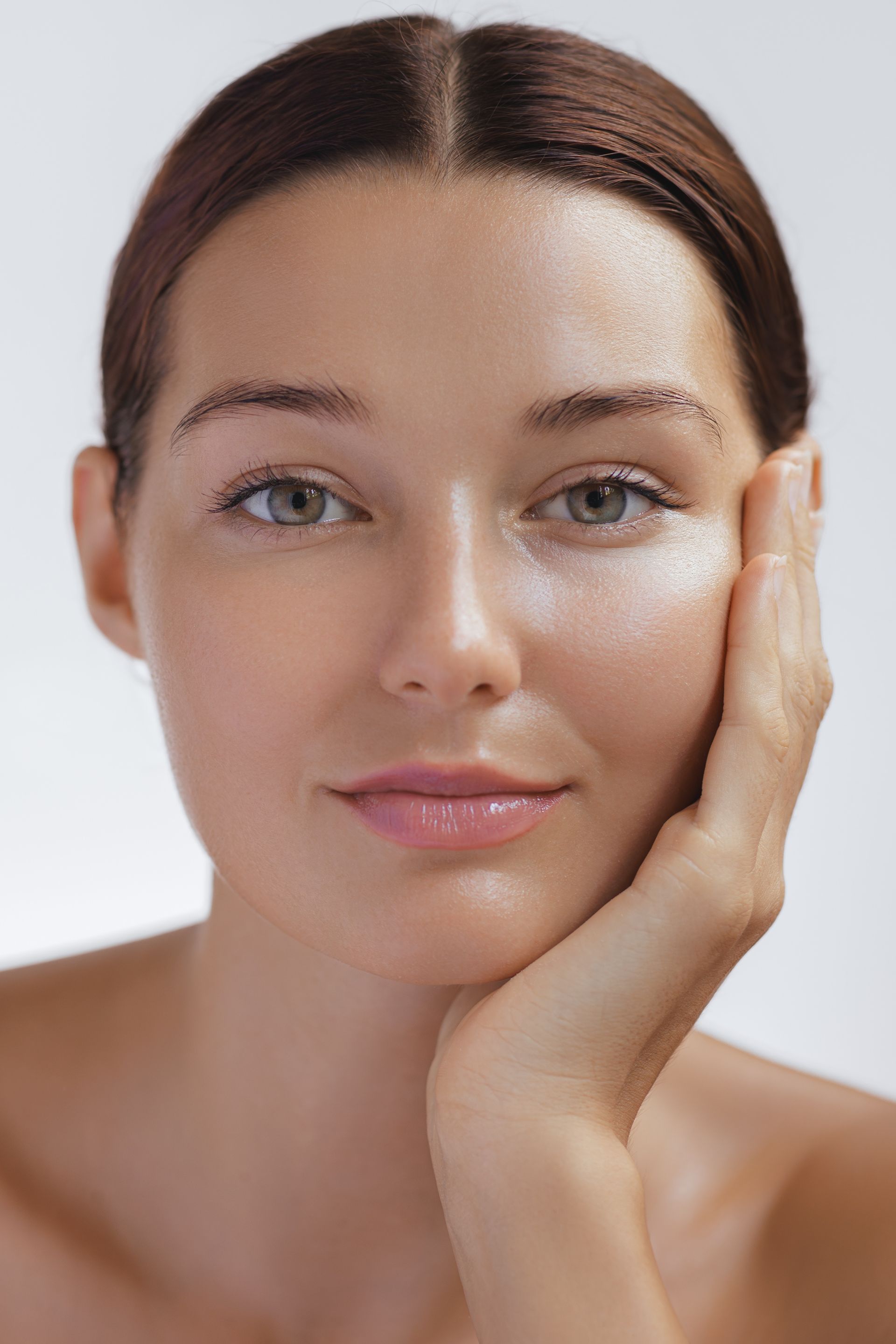 A woman is getting a botox injection in her lips.