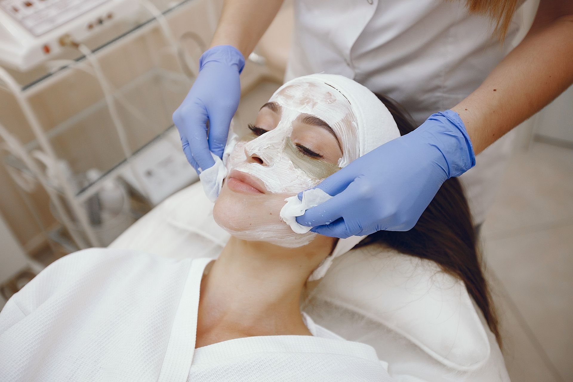 A woman is getting a facial treatment at a beauty salon.