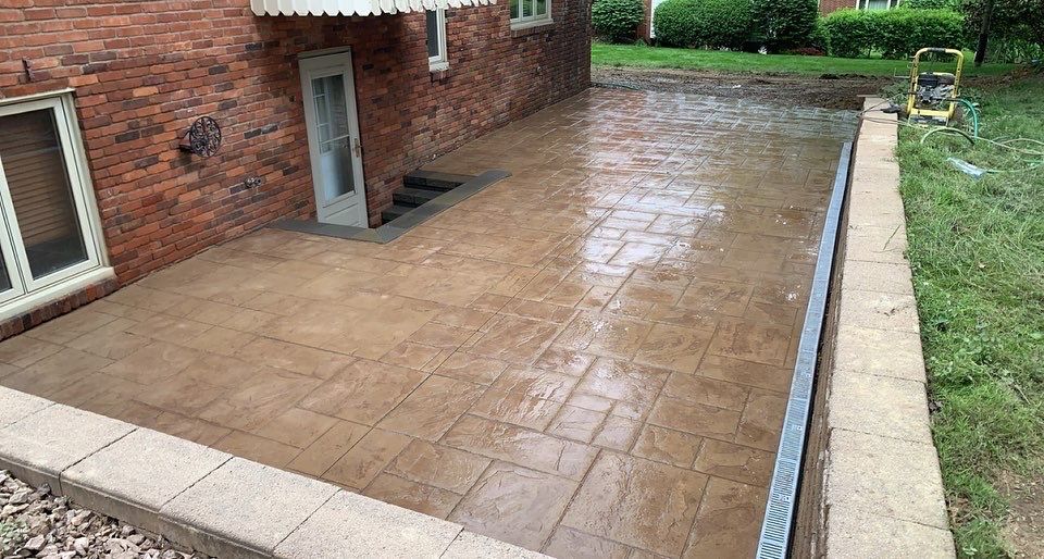 A brick house with a patio in front of it.