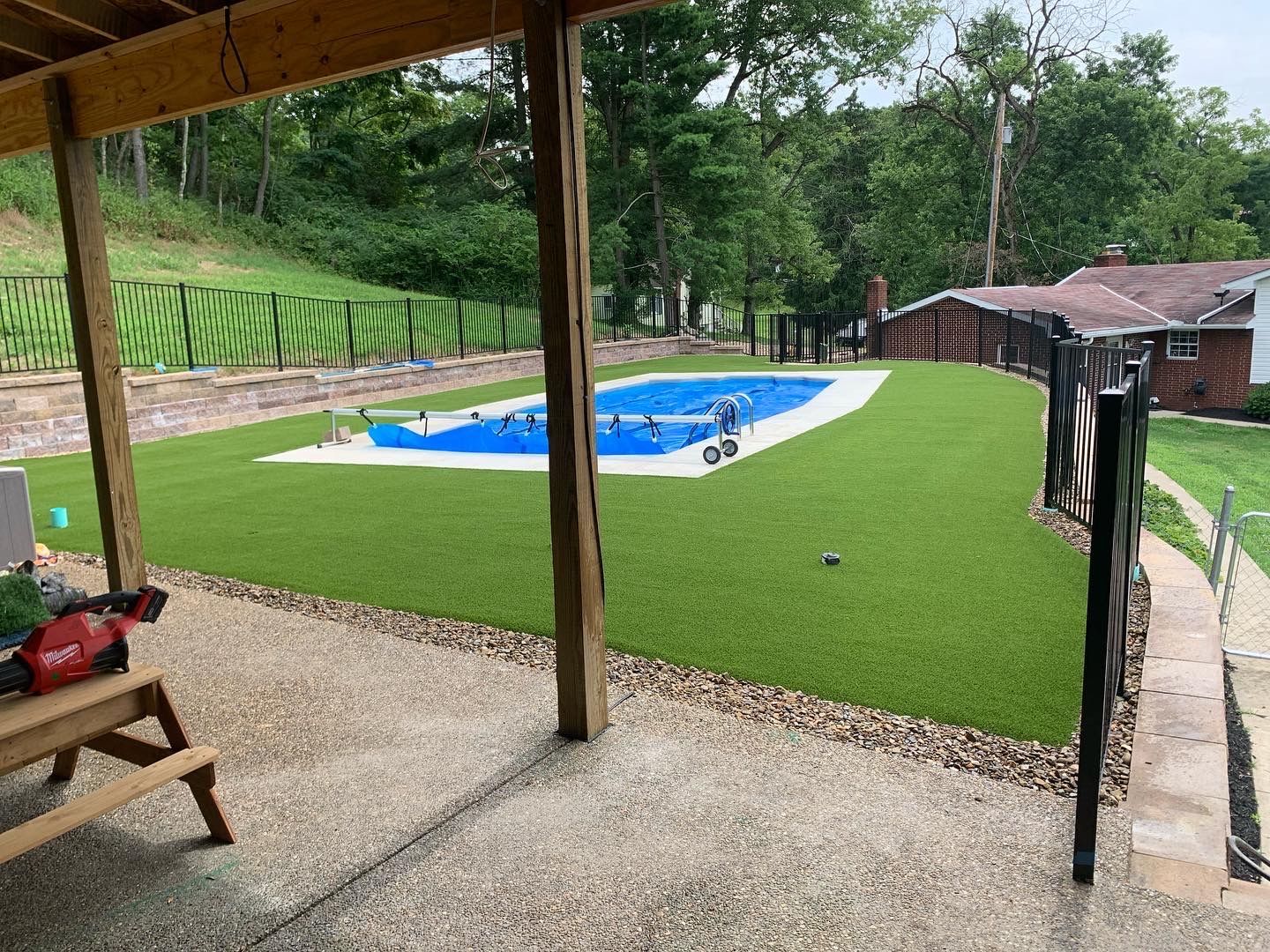 A backyard with a swimming pool and a picnic table.