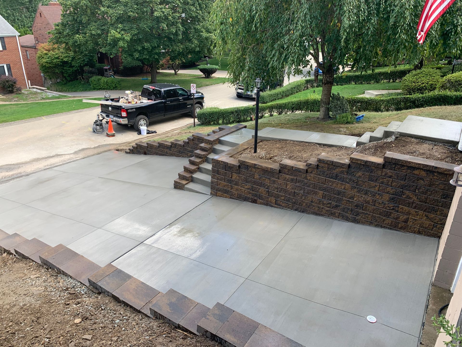 A black truck is parked in the driveway of a house.