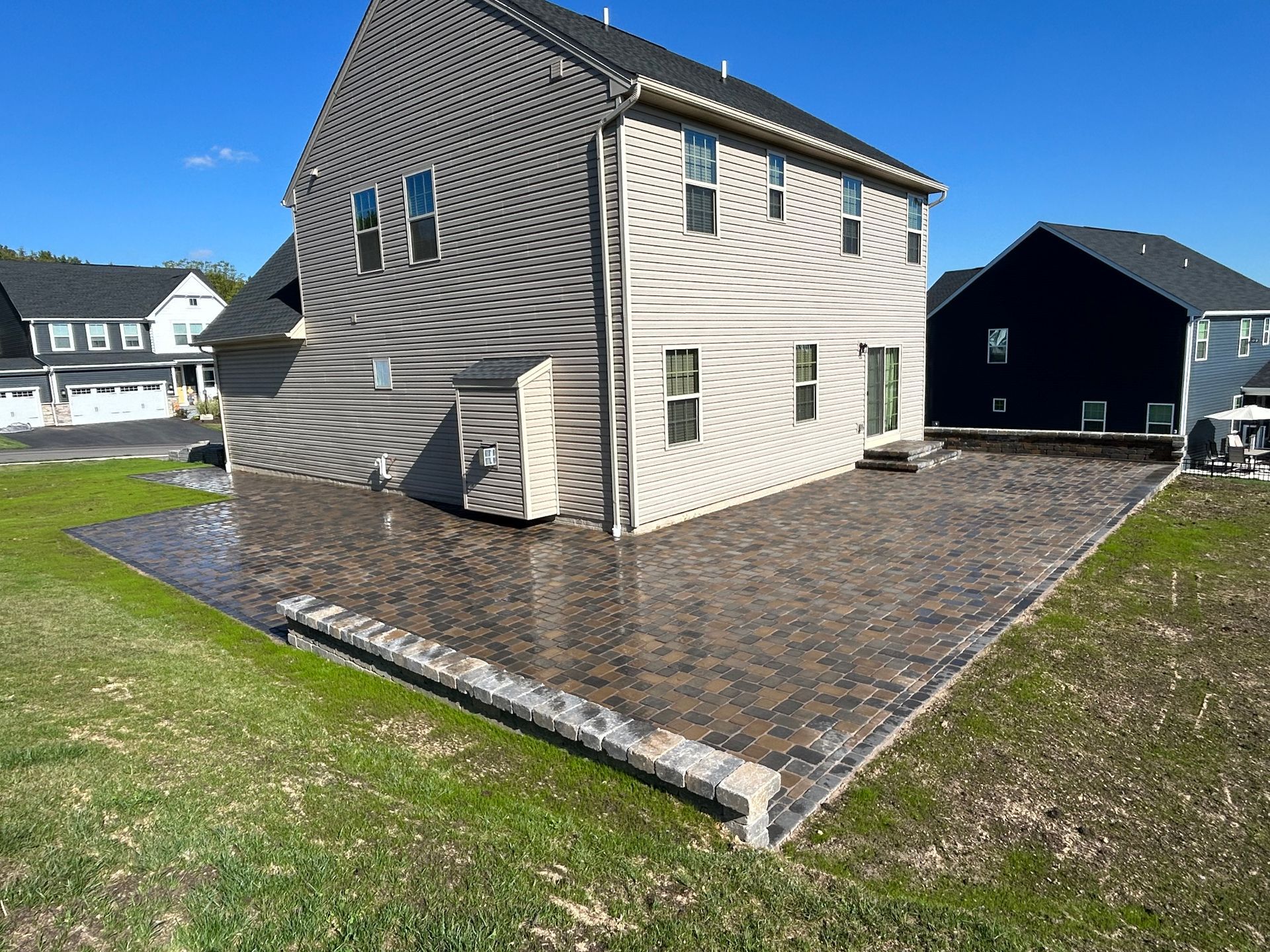 A large house with a large patio in front of it.