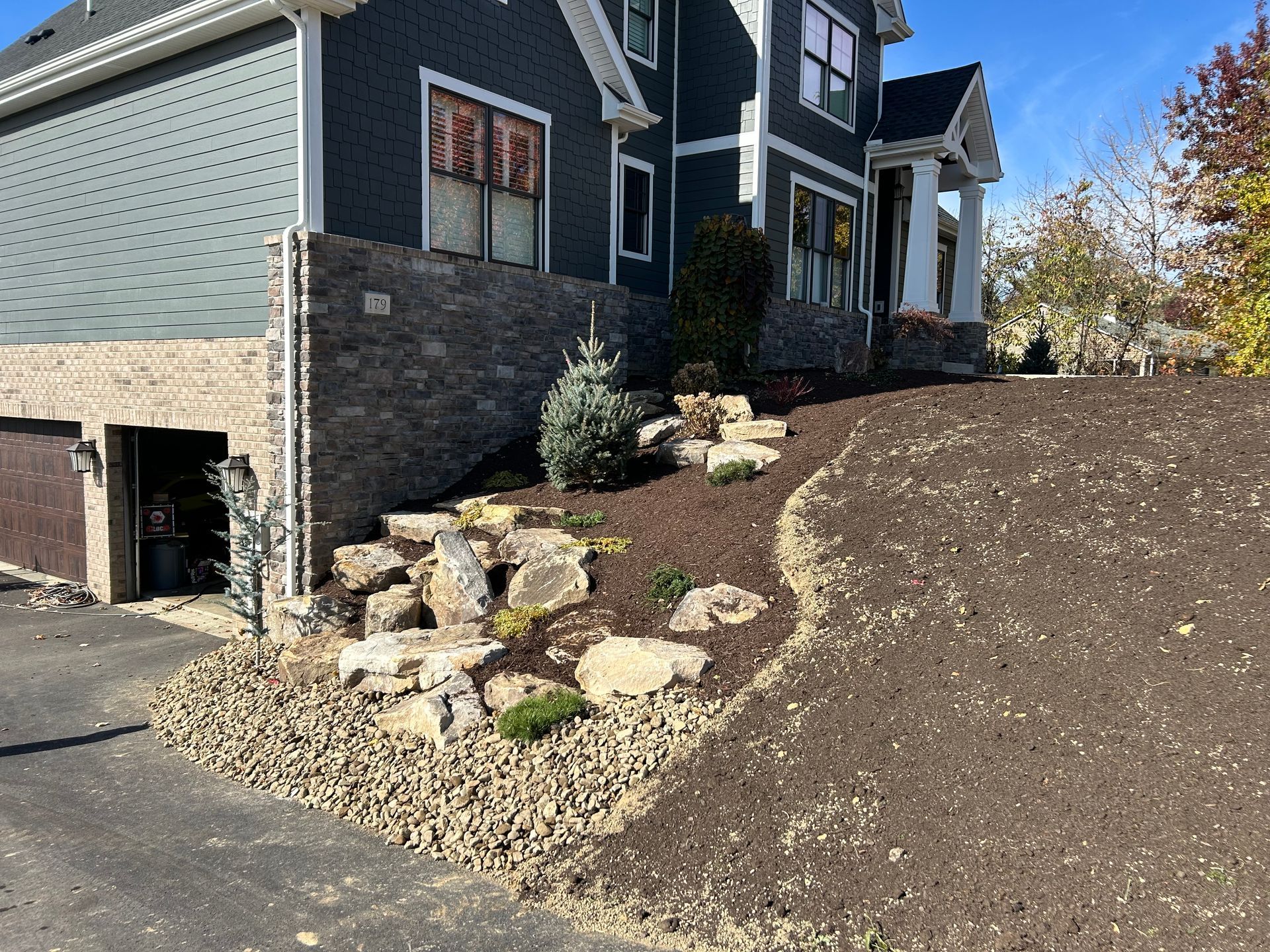 A large house with a lot of rocks in front of it.