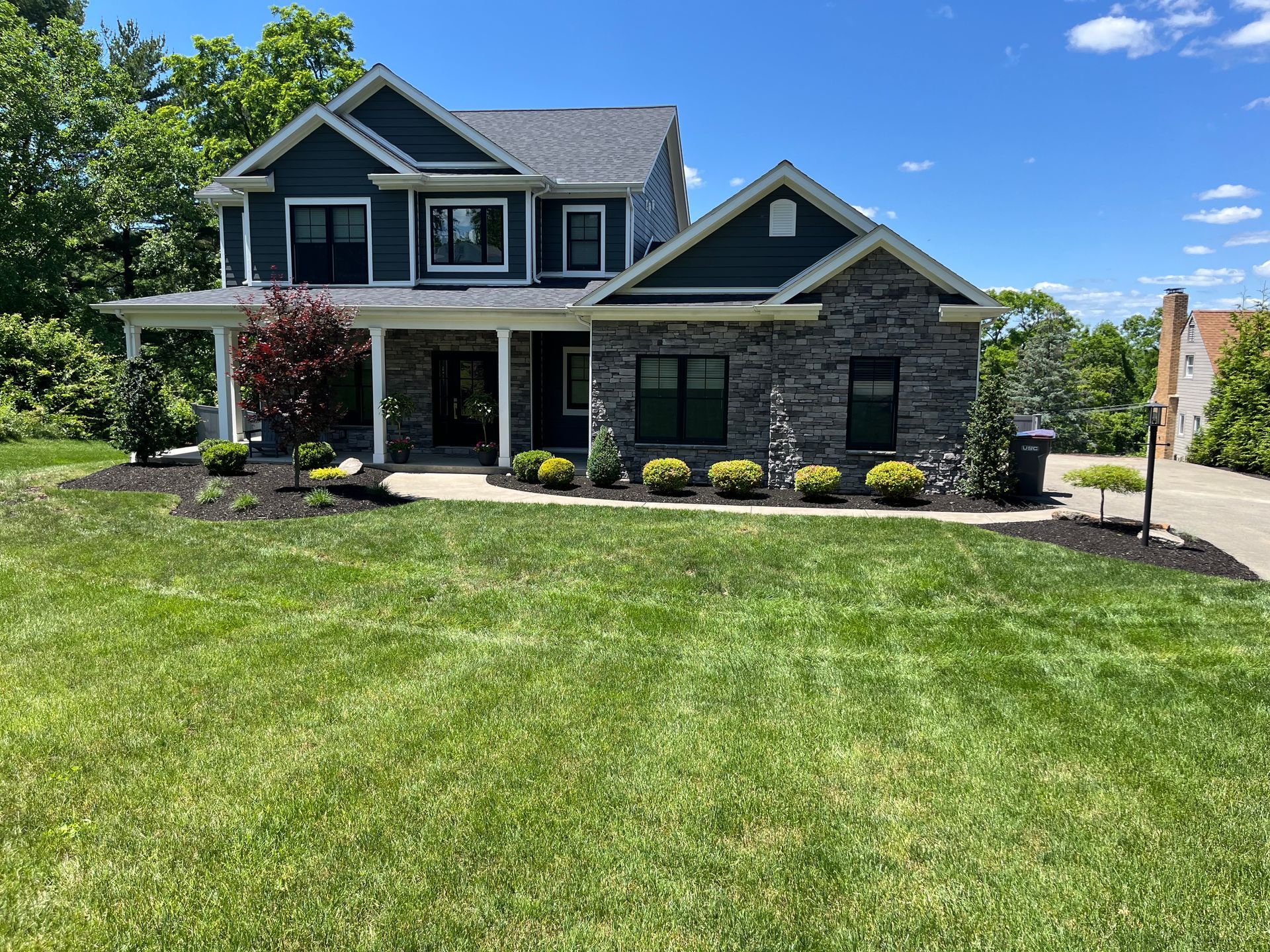 A large house with a lush green lawn in front of it.