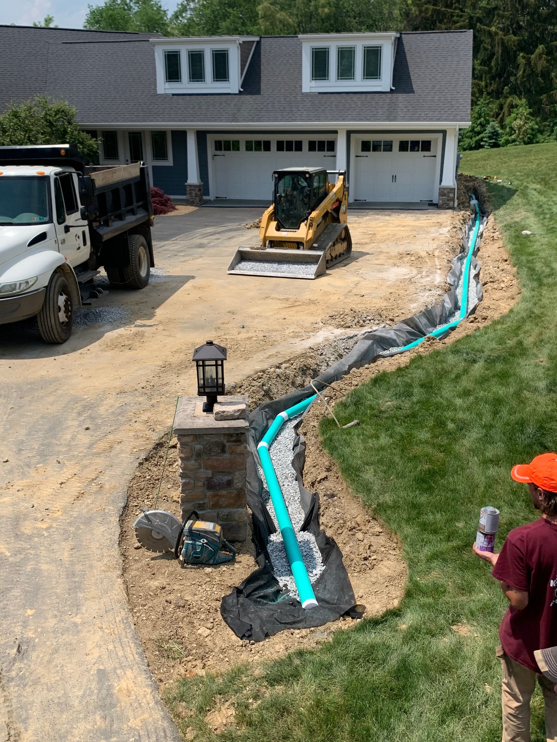 A dump truck is parked in front of a house.