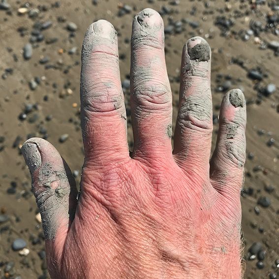 image of clay covered artist's hand