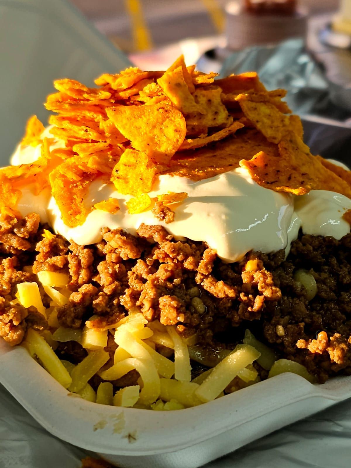 Nacho spud with potato, sour cream, corn ships, cheese