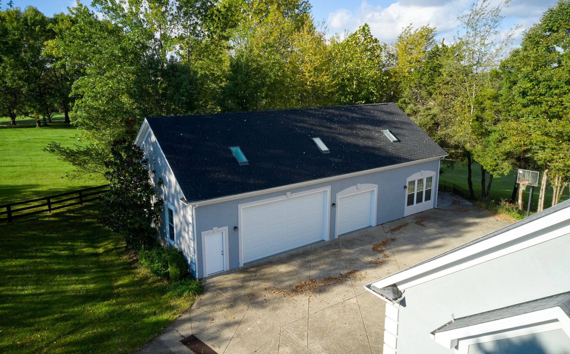 An aerial view of a garage with a black roof