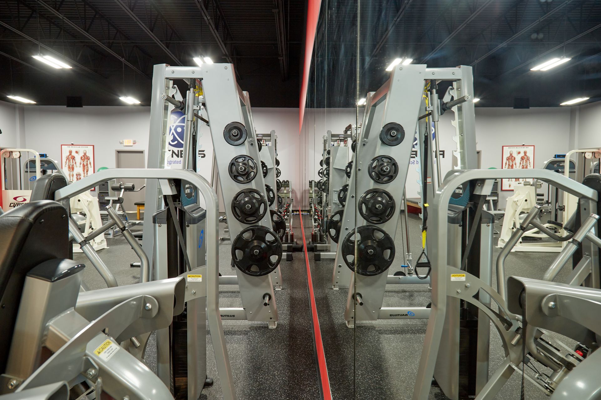 A gym with a lot of exercise equipment and a red line
