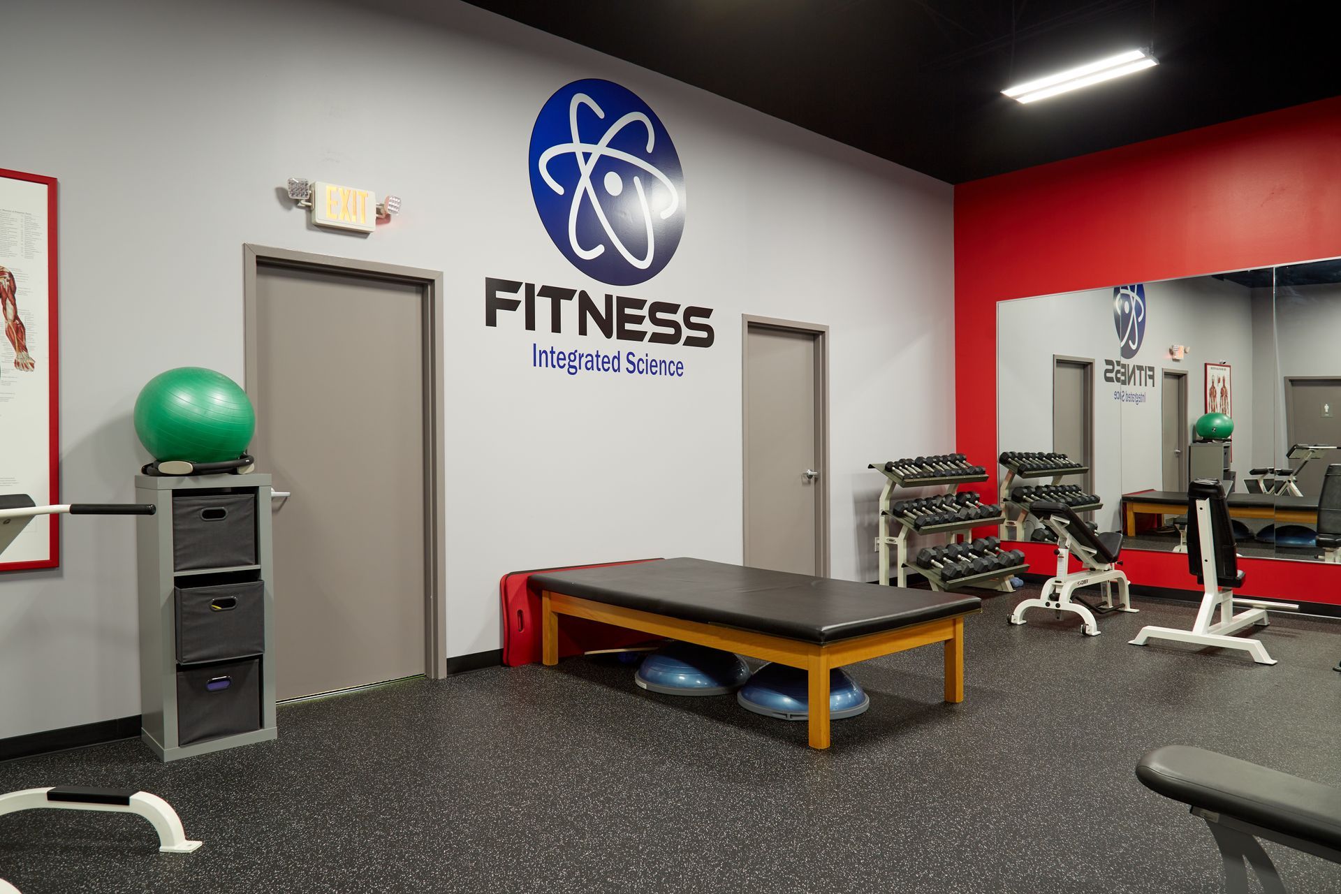 A gym with a table and a large mirror.