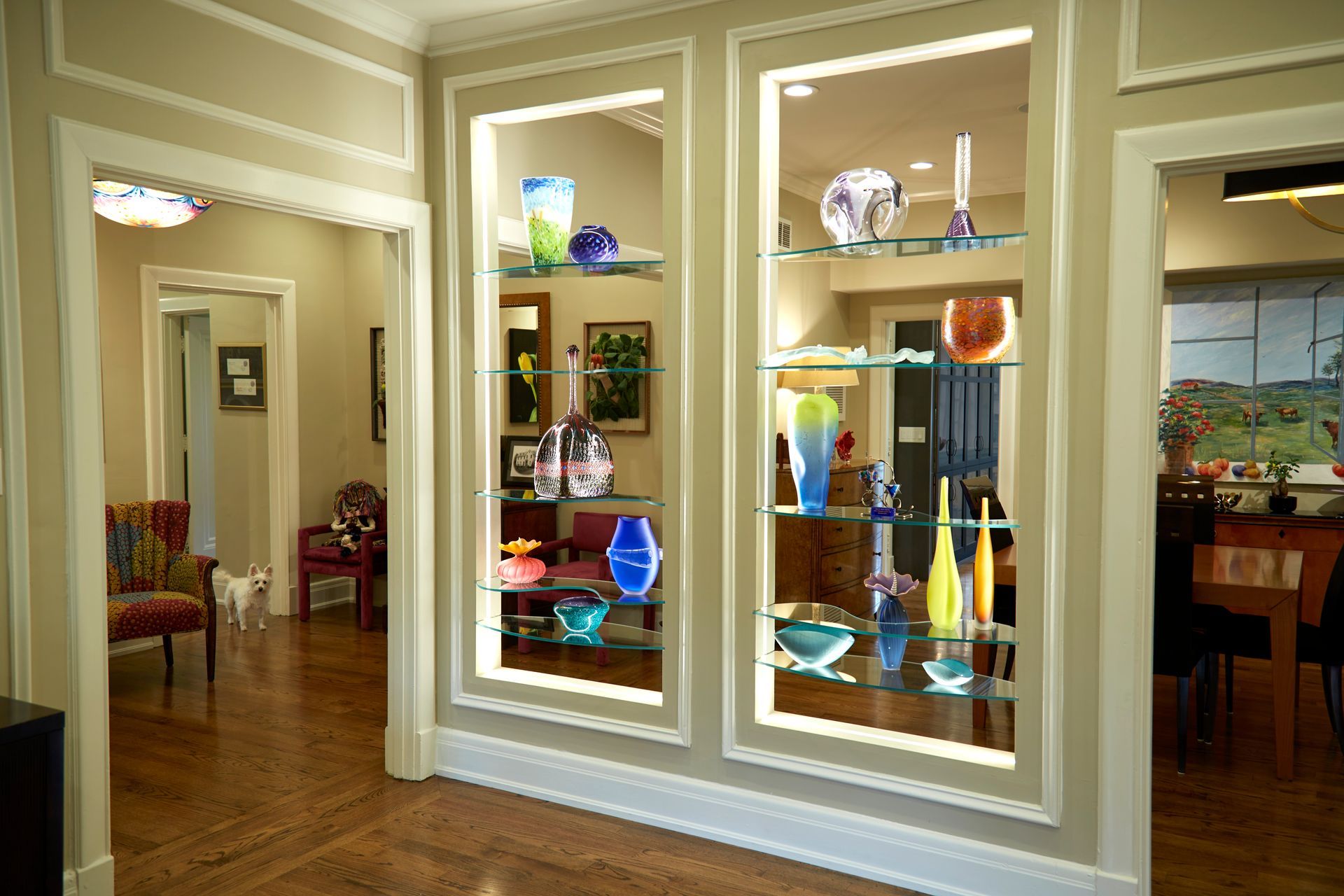 A living room with a display of vases on shelves