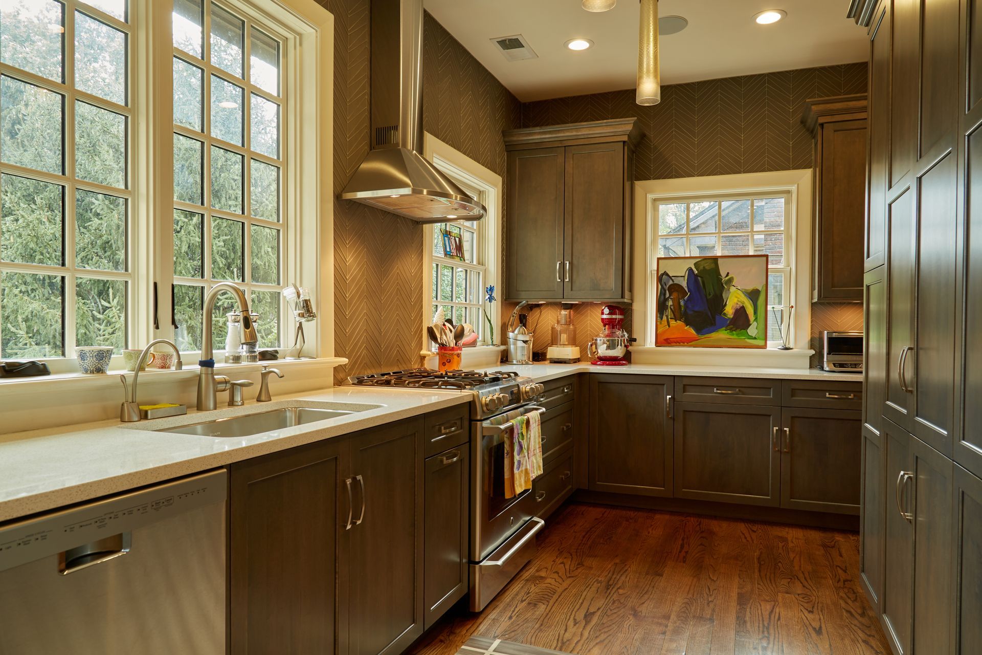 A kitchen with stainless steel appliances and gray cabinets