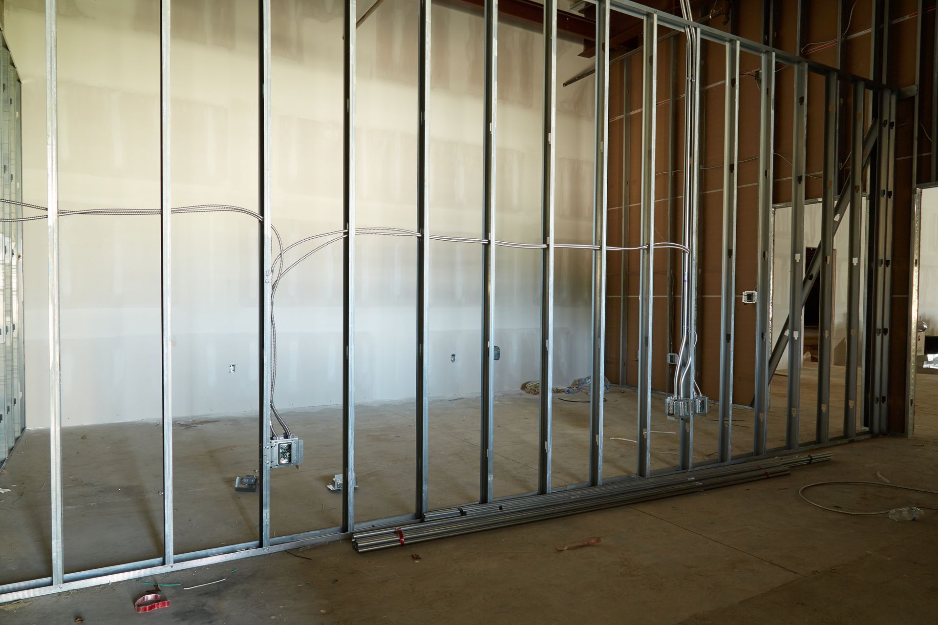 An empty room with a metal frame on the wall