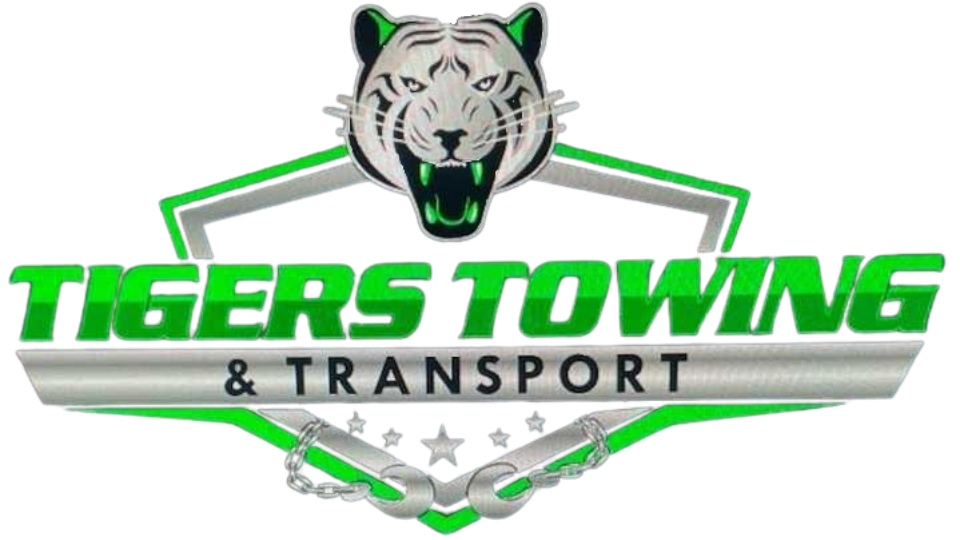 Logo of Tigers Towing & Transport, Cypress Texas, featuring a green tow truck with a car and a tiger graphic.