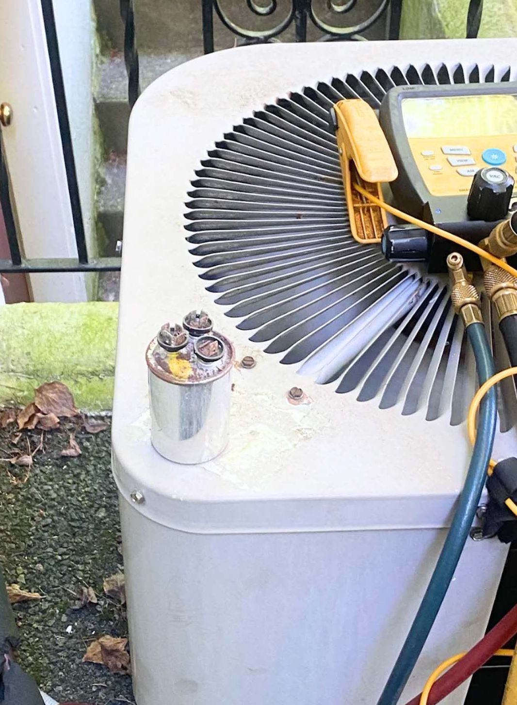 A close up of an air conditioner with a hose attached to it