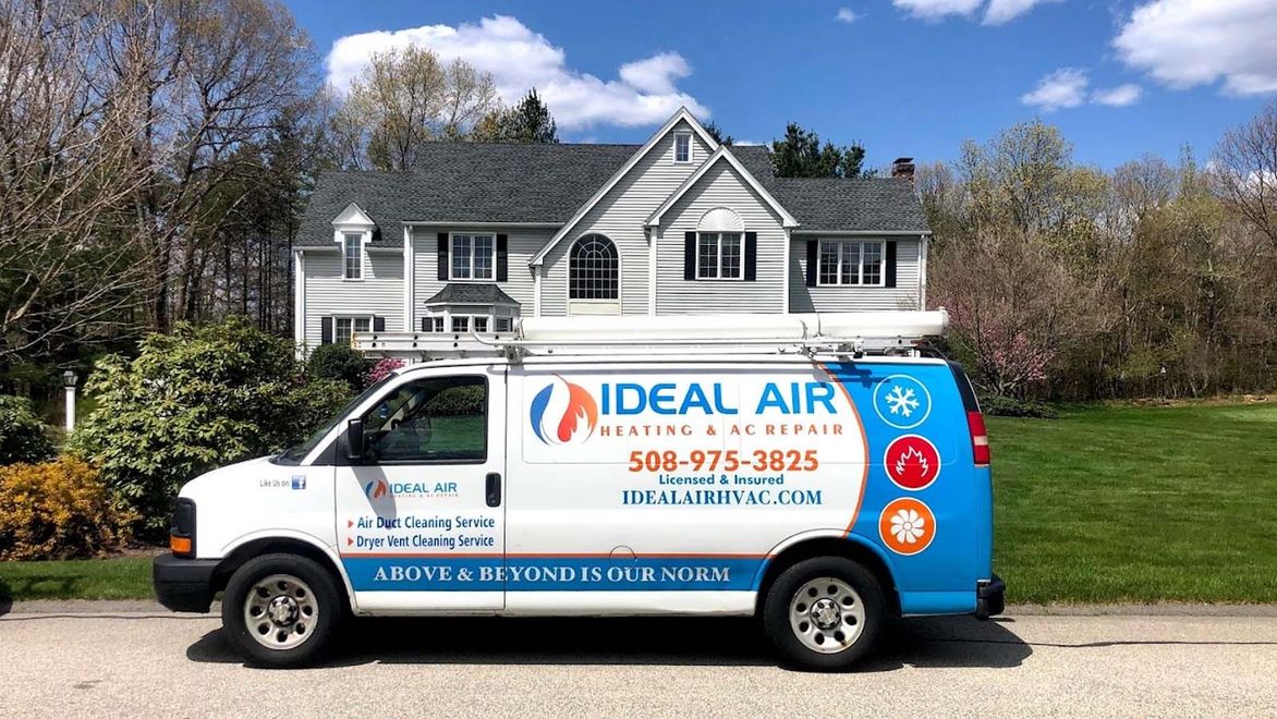 An ideal air van is parked in front of a house.