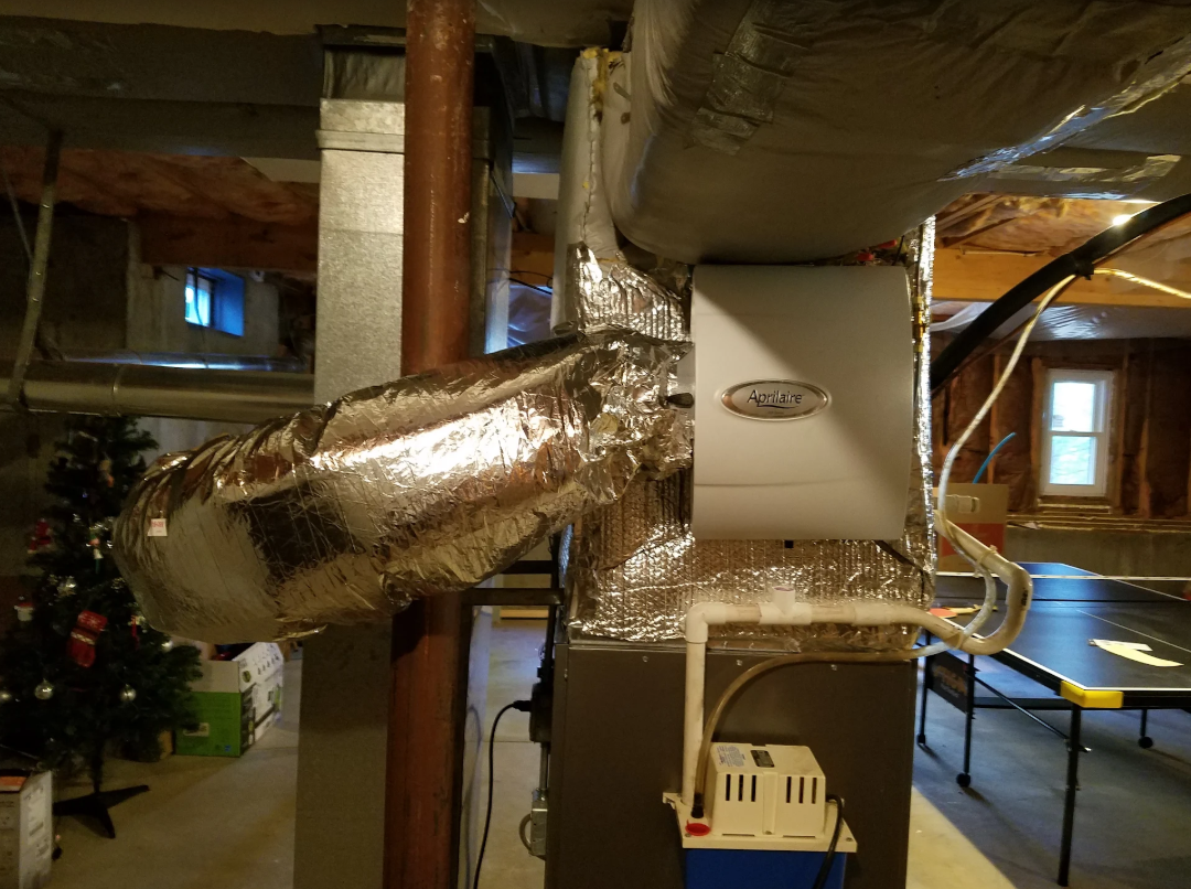 An air conditioner is being installed in a basement in a house.